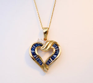 10K yellow gold heart-shaped pendant with Blue Sapphires and small Diamonds for the sparkle