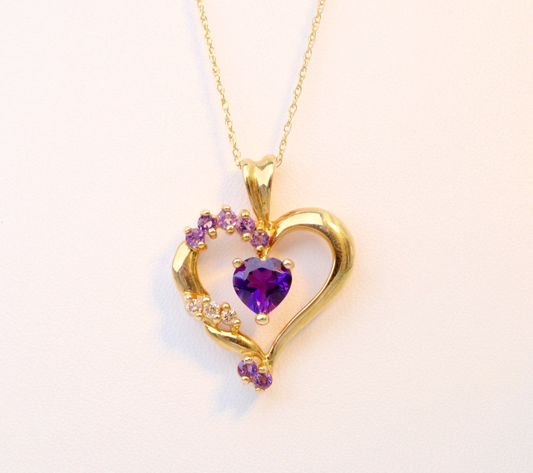 Heart-shaped pendant set with one center Amethyst and 3 side Diamonds