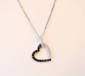 Heart-shaped diamond pendant with 1/2 black and 1/2 white diamonds, 14K white gold