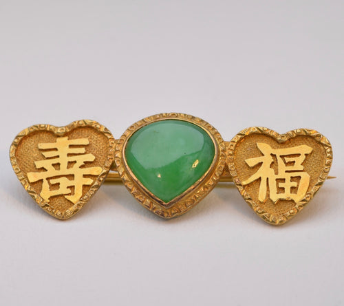 Vivid green Jadeite brooch in 18K yellow gold with Chinese characters