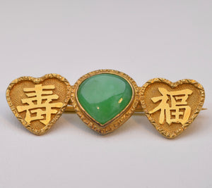 Vivid green Jadeite brooch in 18K yellow gold with Chinese characters
