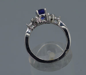14K white gold ring with one center oval Tanzanite and six side Diamond baguettes