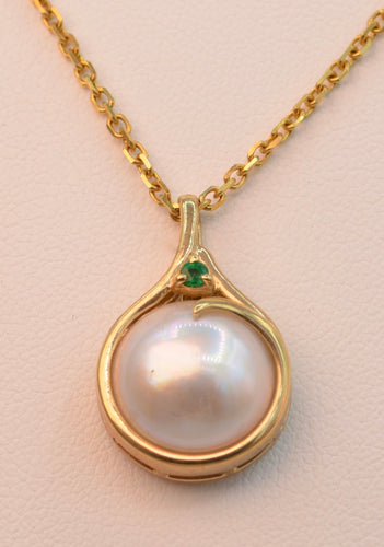 14K yellow gold Moby Pearl pendant with 15mm Moby Pearl and one deep green Emerald trim