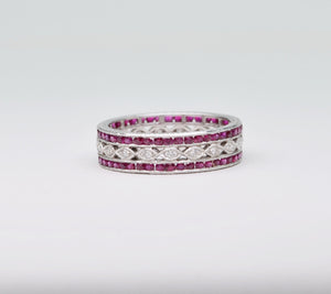 18K white gold wedding band with 2 rows of Rubies framing one center row of diamonds