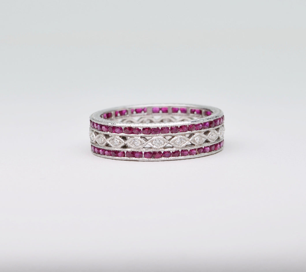 18K white gold wedding band with 2 rows of Rubies framing one center row of diamonds