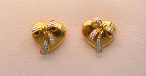 18k yellow gold, heart-shaped post  earrings with diamond bows.