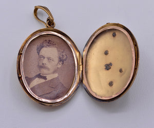 14K yellow gold locket with photo inside decorated with Rubies and seed pearls